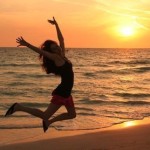 joyful-woman_jump_on-beach-